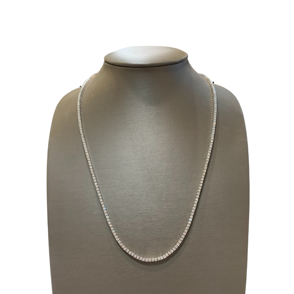 a necklace on a mannequin with a white background