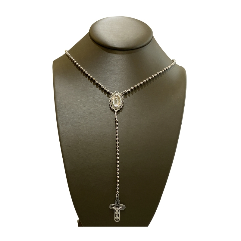 a necklace on a mannequin with a cross