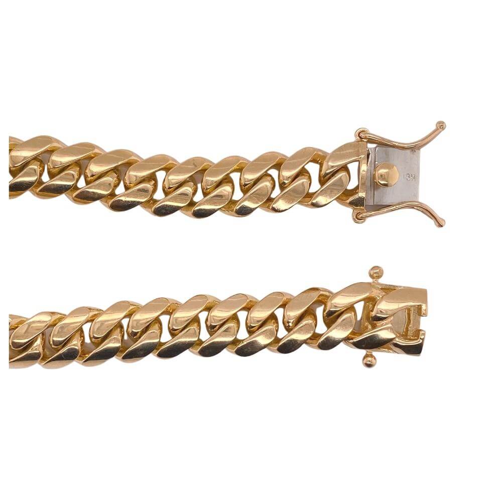 a pair of gold bracelets on a white background