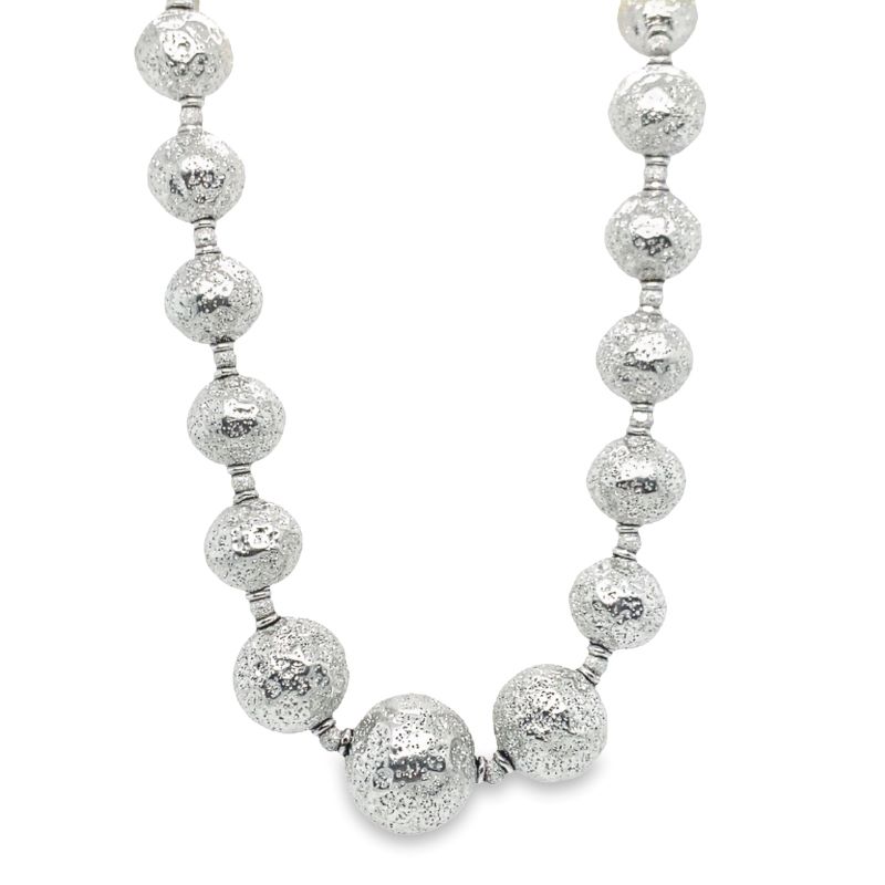 a necklace with silver balls on it
