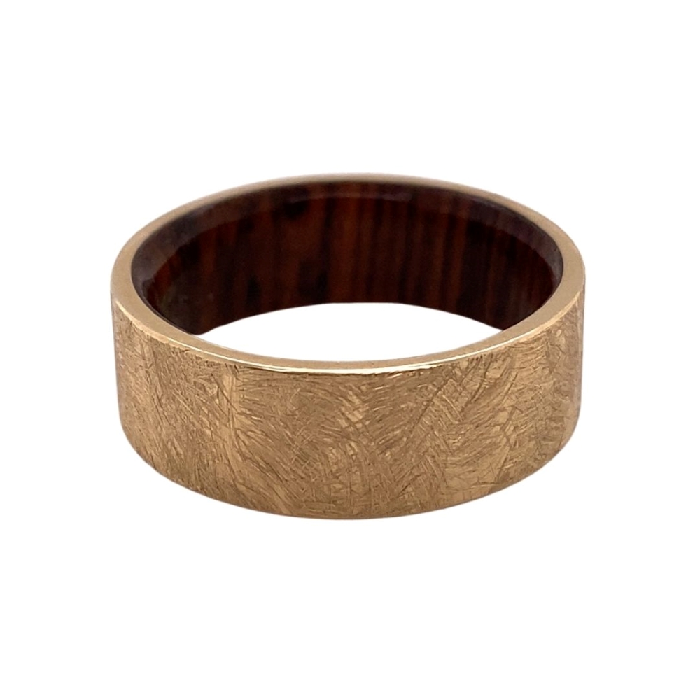 a gold ring with a wooden inlay
