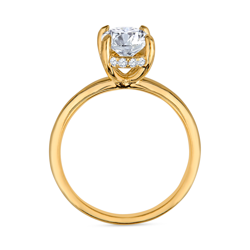 a yellow gold ring with a white diamond in the center