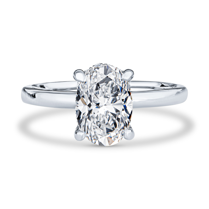 an oval cut diamond ring on a white background