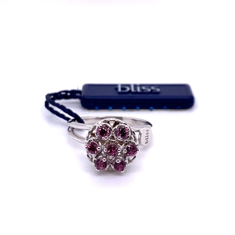 a ring with pink stones is sitting next to a usb drive