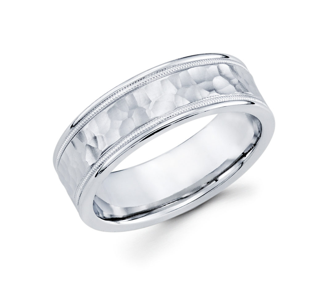 a wedding band with a textured design in white gold