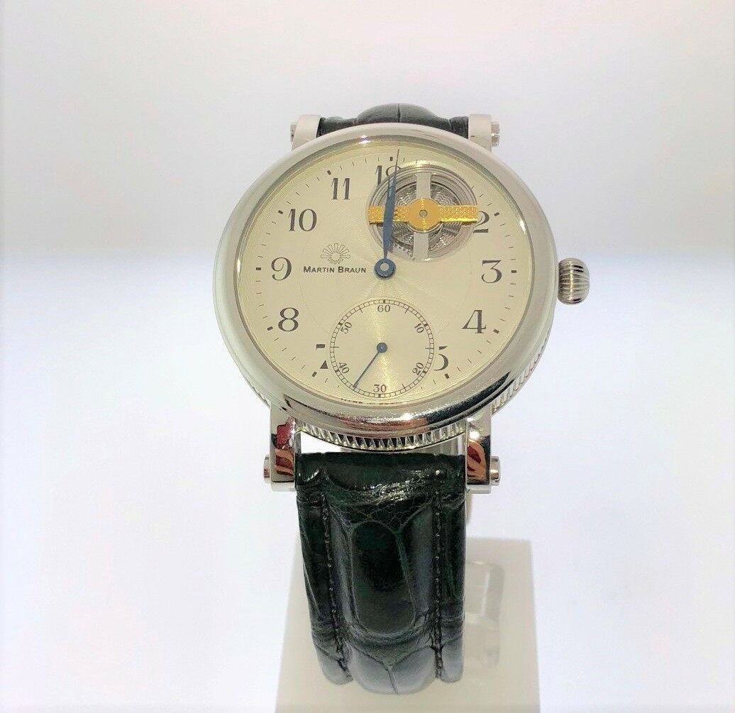 a watch sitting on top of a white surface