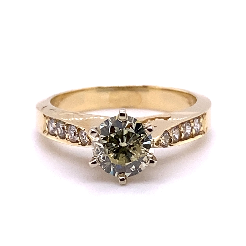 a yellow gold ring with a brown diamond