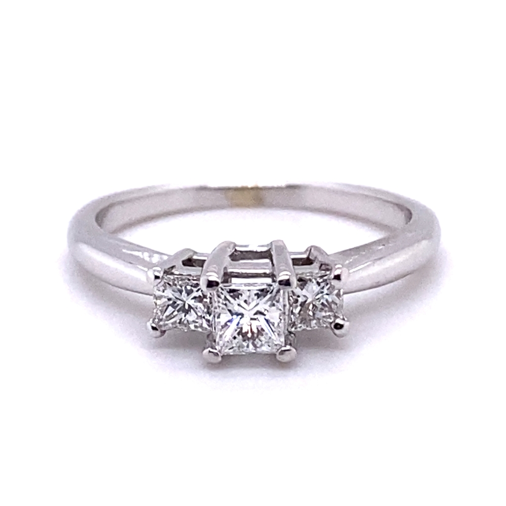 a three stone ring with two princess cut diamonds