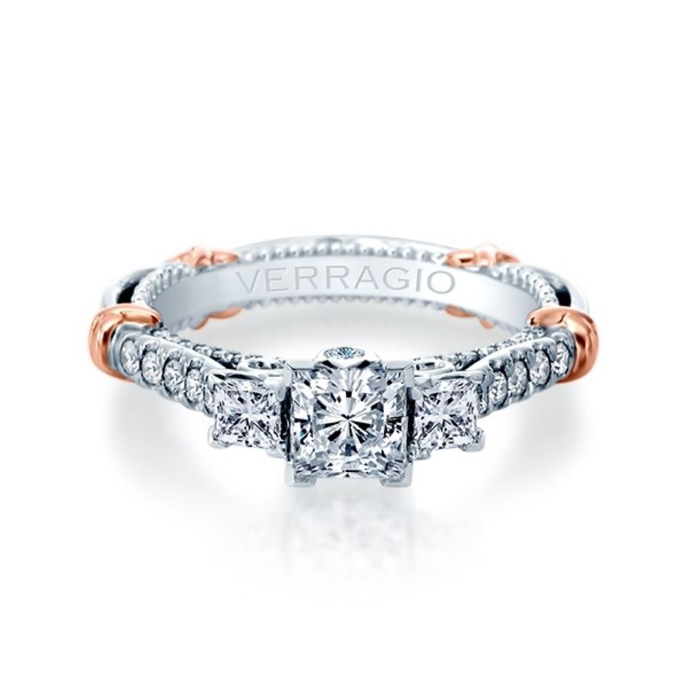 a diamond engagement ring with three diamonds on the band