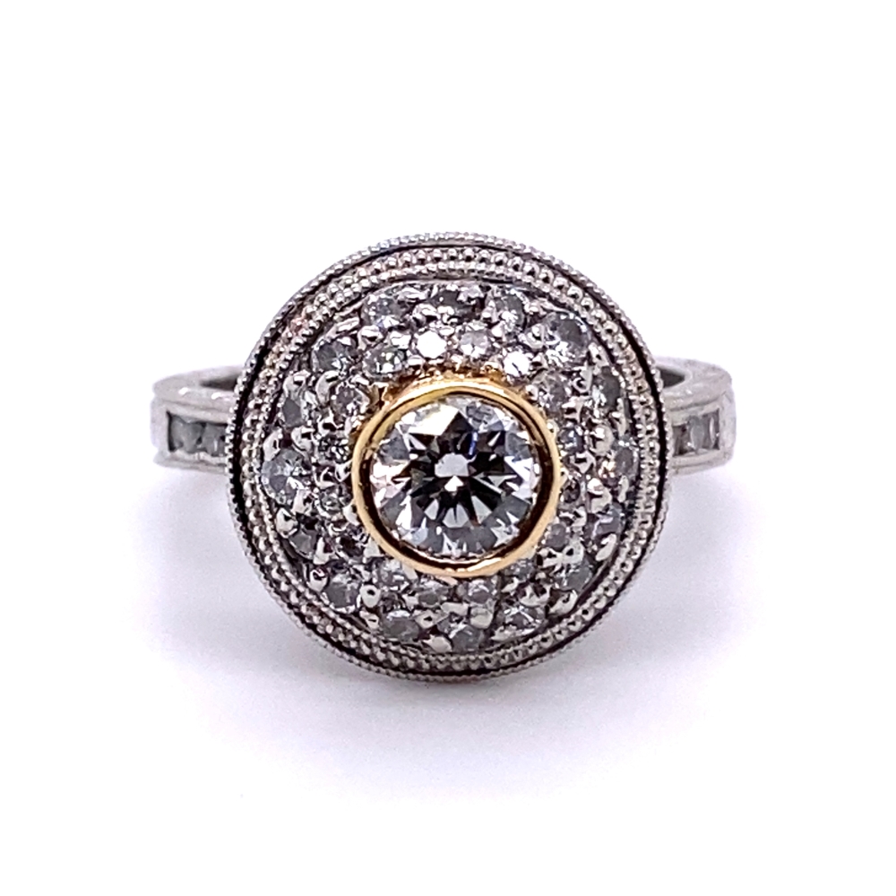 a diamond ring with two tone gold and white diamonds