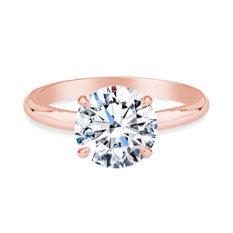 a rose gold engagement ring with a round diamond