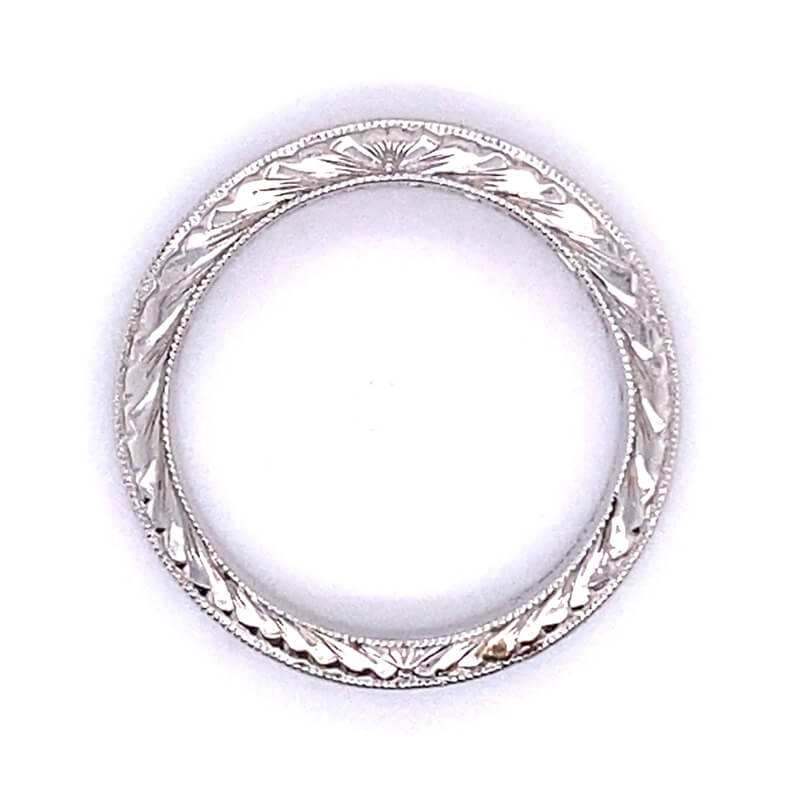 a silver ring with intricate designs on it
