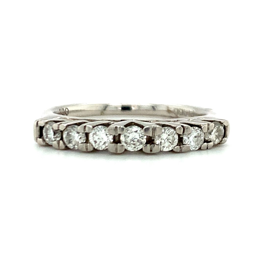 a white gold ring with five round diamonds