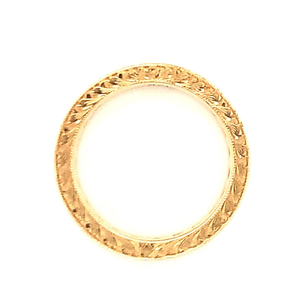 a gold colored ring on a white background