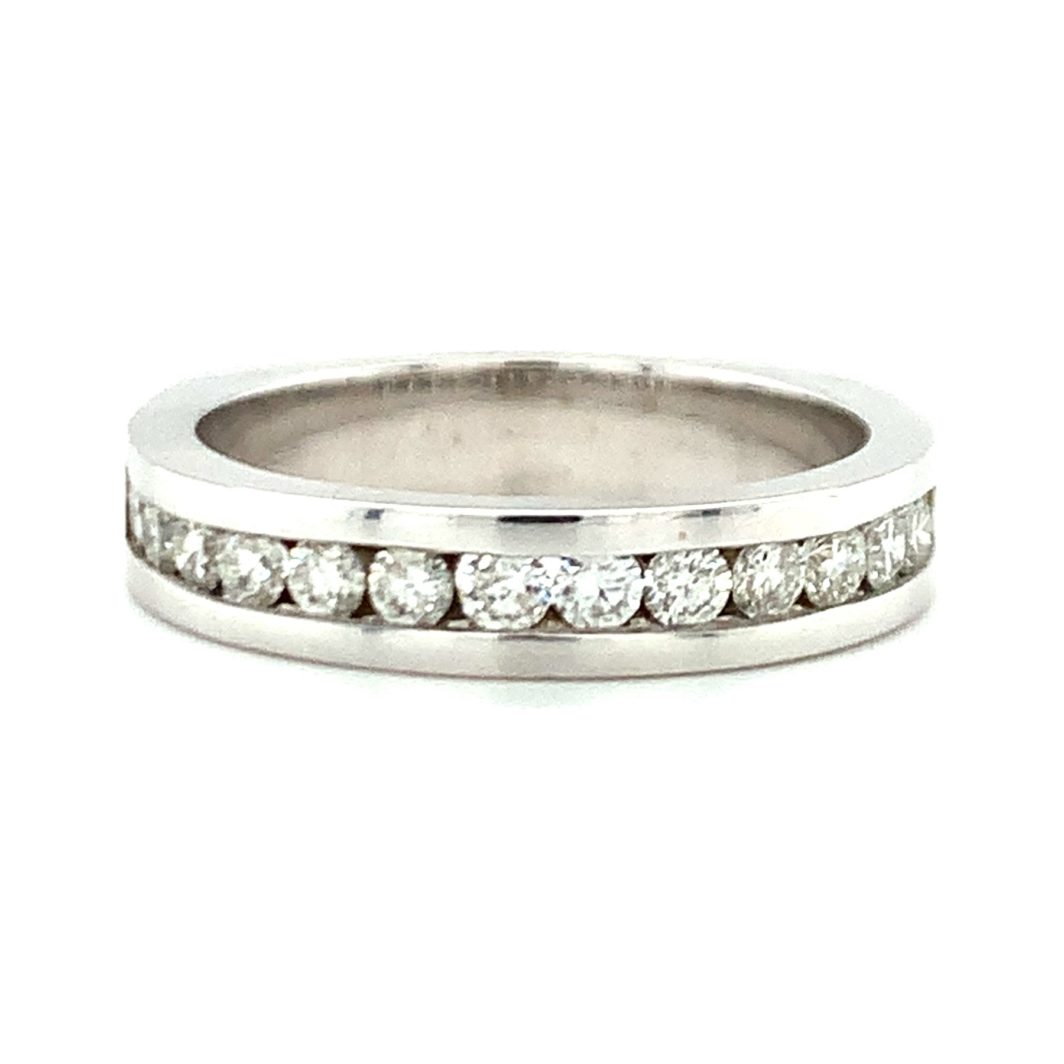 a diamond set wedding ring on a white background