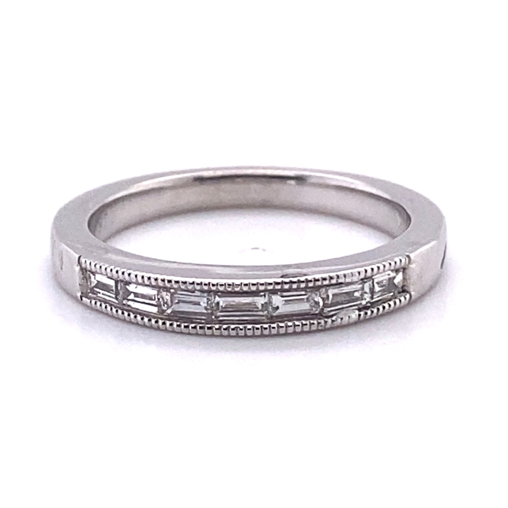 a white gold wedding band with three baguetts