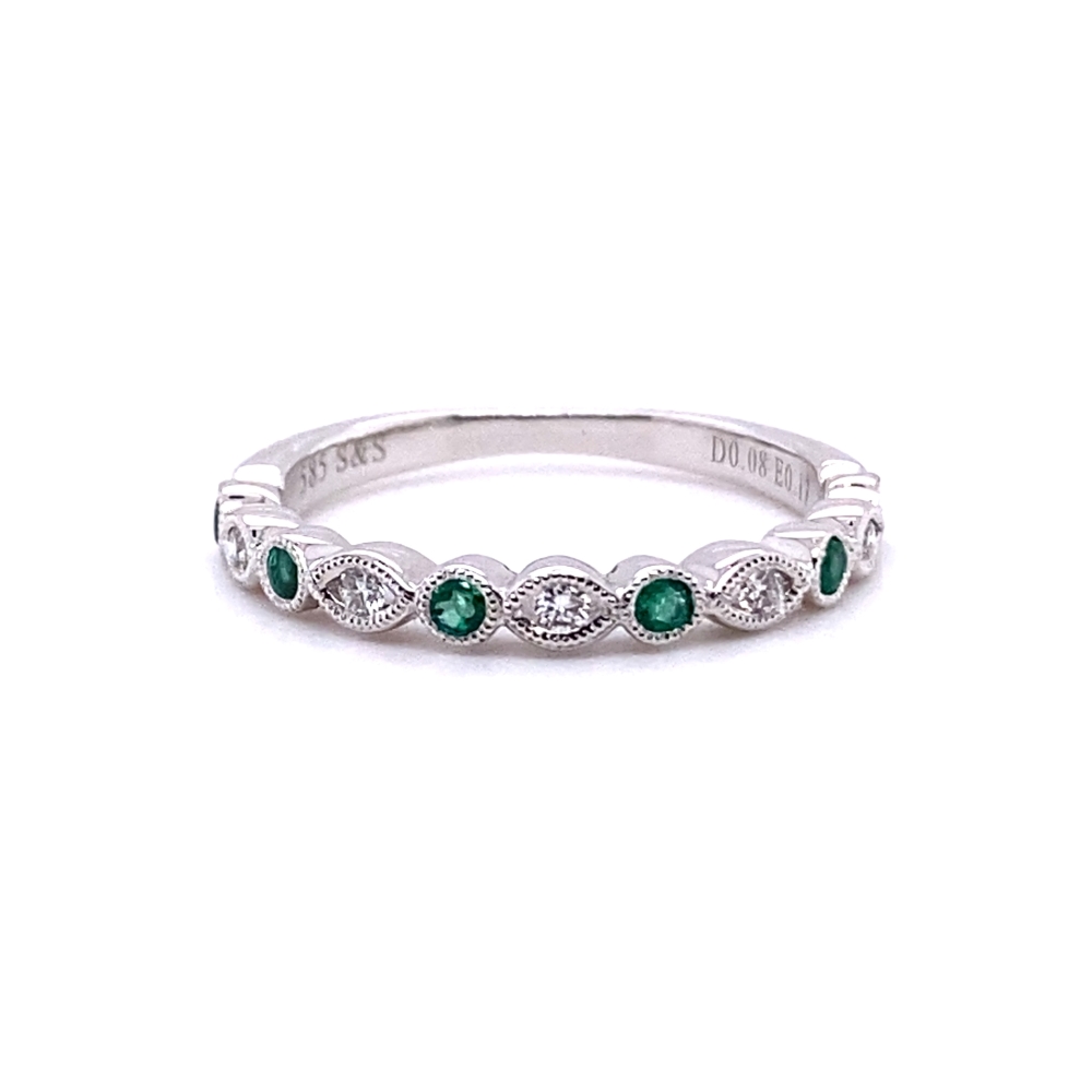 a white gold ring with emeralds and diamonds