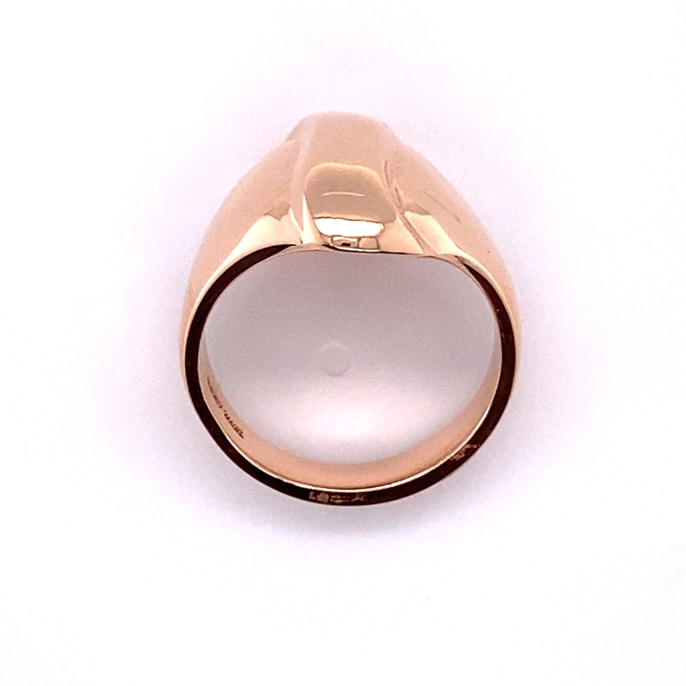 a gold signet ring on a white background