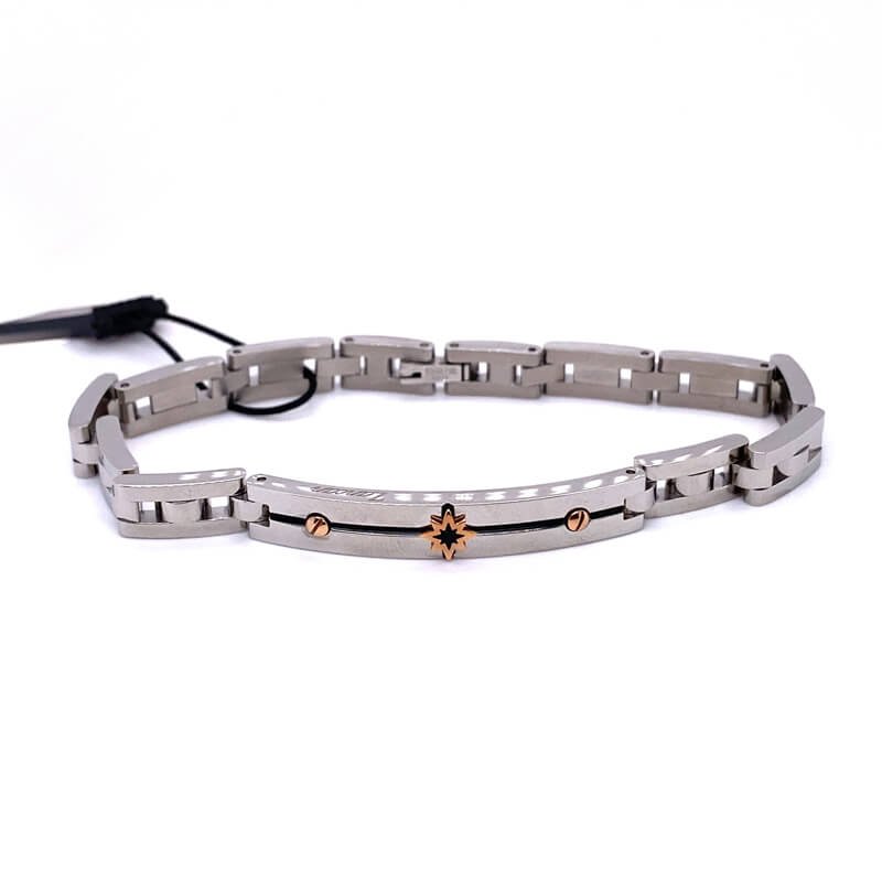 a silver bracelet with gold accents on a white background