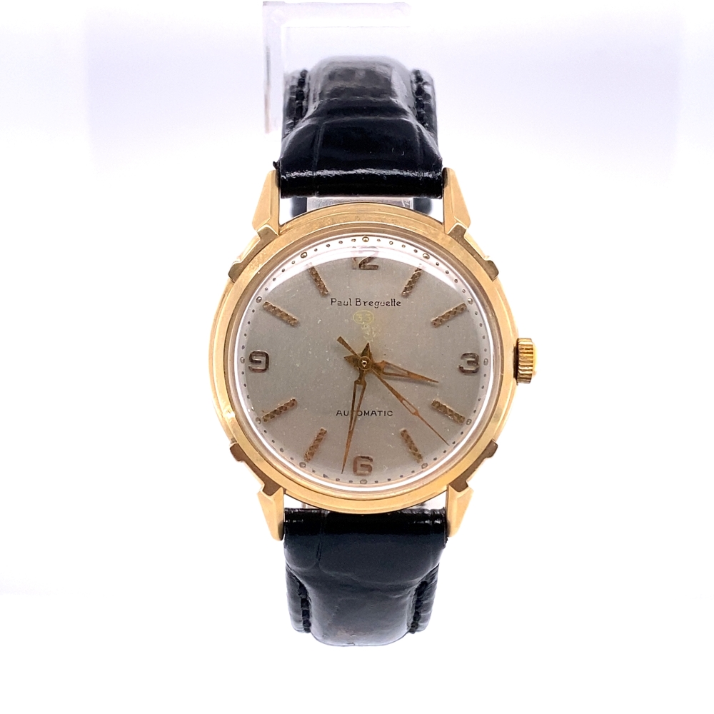 a gold watch with black leather straps on a white background