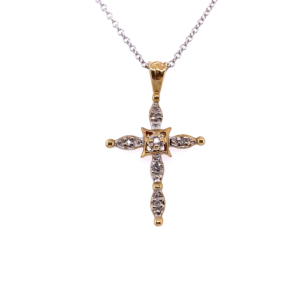 a cross pendant with two tone gold and white diamonds