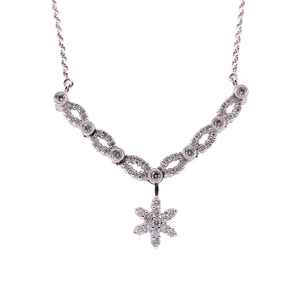 a silver necklace with a flower on it