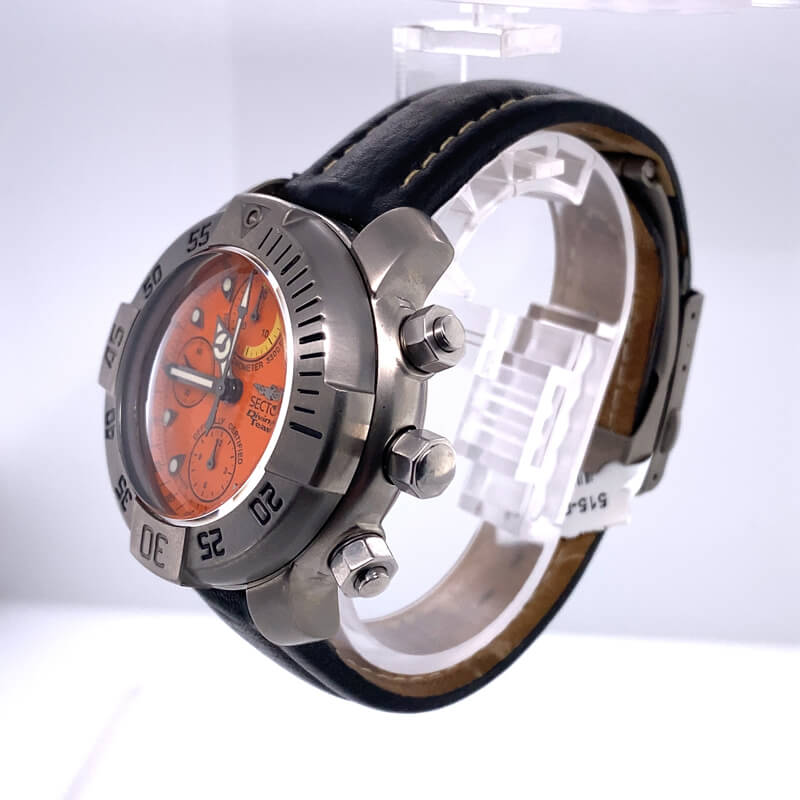 a watch with an orange face and black leather strap