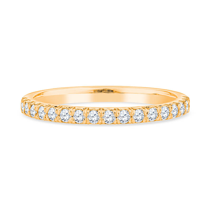 a yellow gold wedding band with diamonds