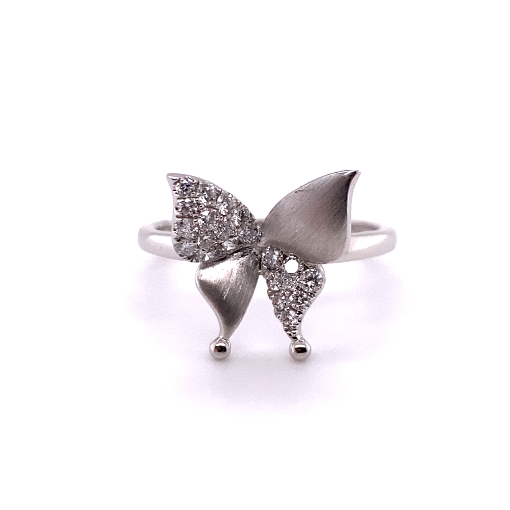a silver ring with a bow on it