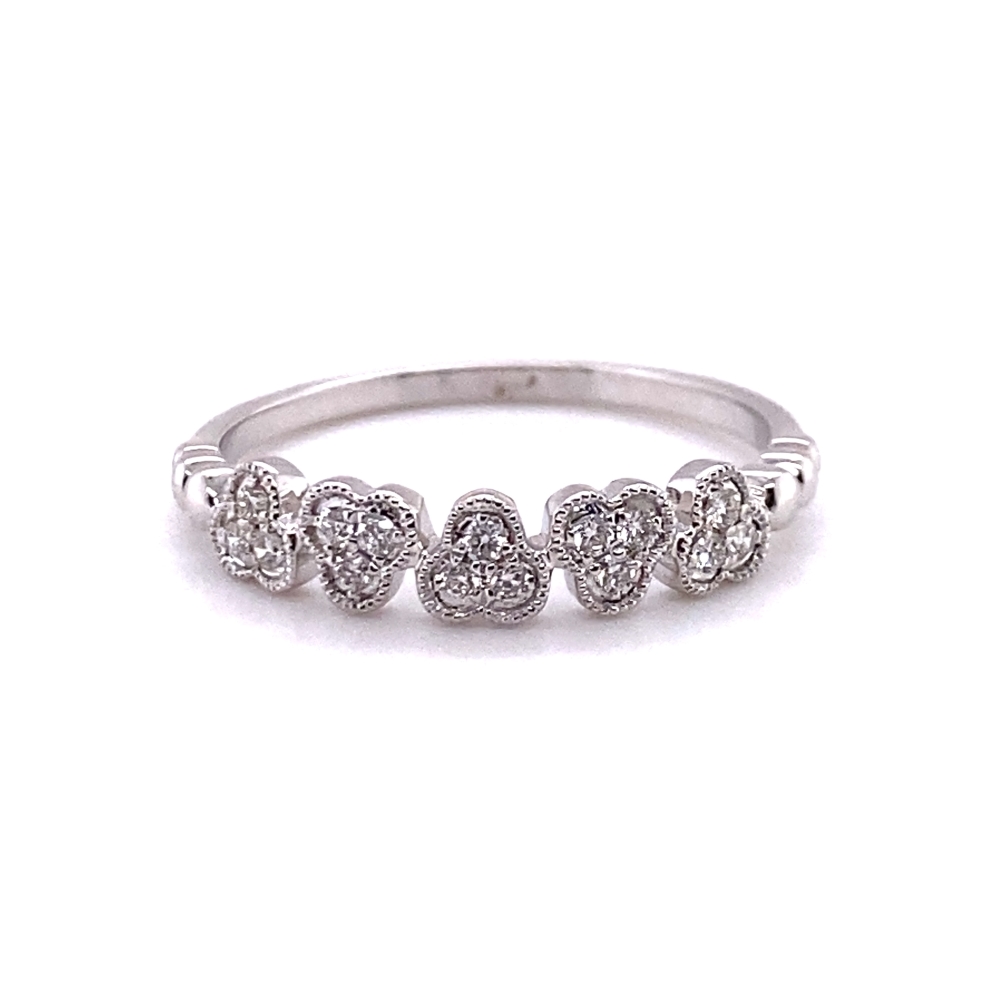 a white gold ring with three hearts on it