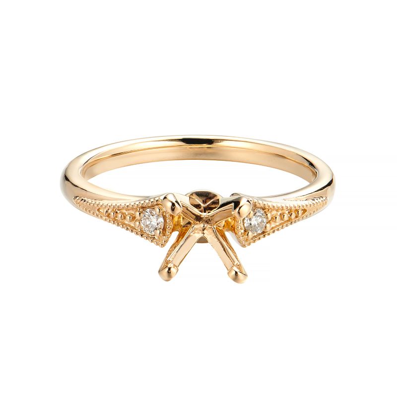 a gold ring with an arrow and two diamonds