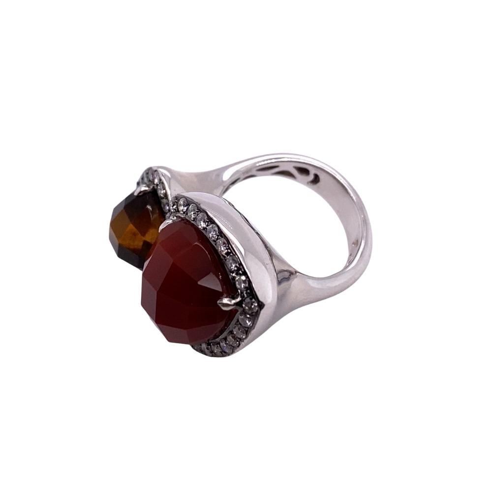 a silver ring with two stones on it