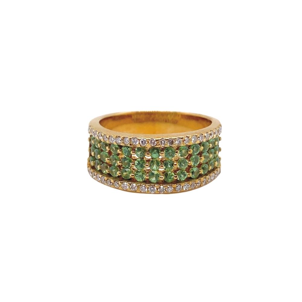 a gold ring with green and white stones