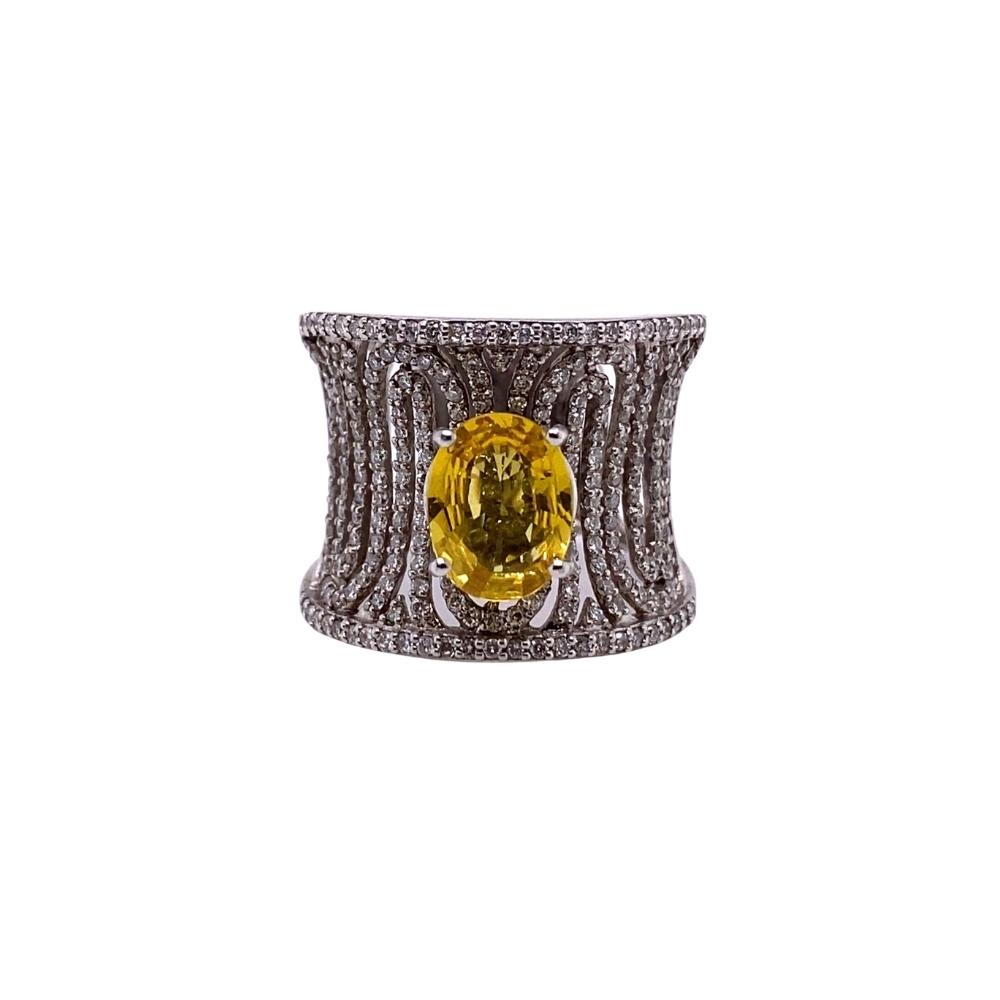 a fancy ring with a yellow diamond in the center