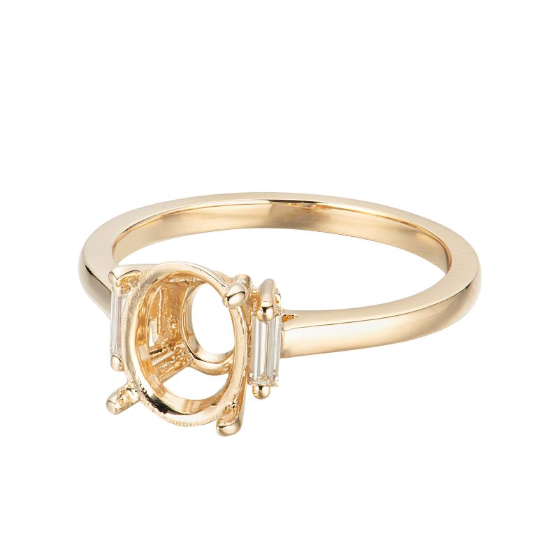 a yellow gold ring with a baguette cut diamond