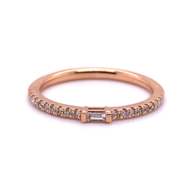 a rose gold ring with two diamonds on it