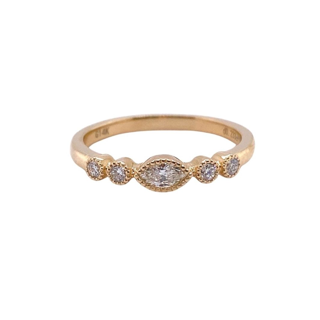 a yellow gold ring with three diamonds