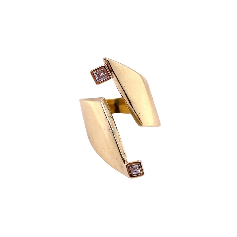 a gold ring with two brown diamonds on it