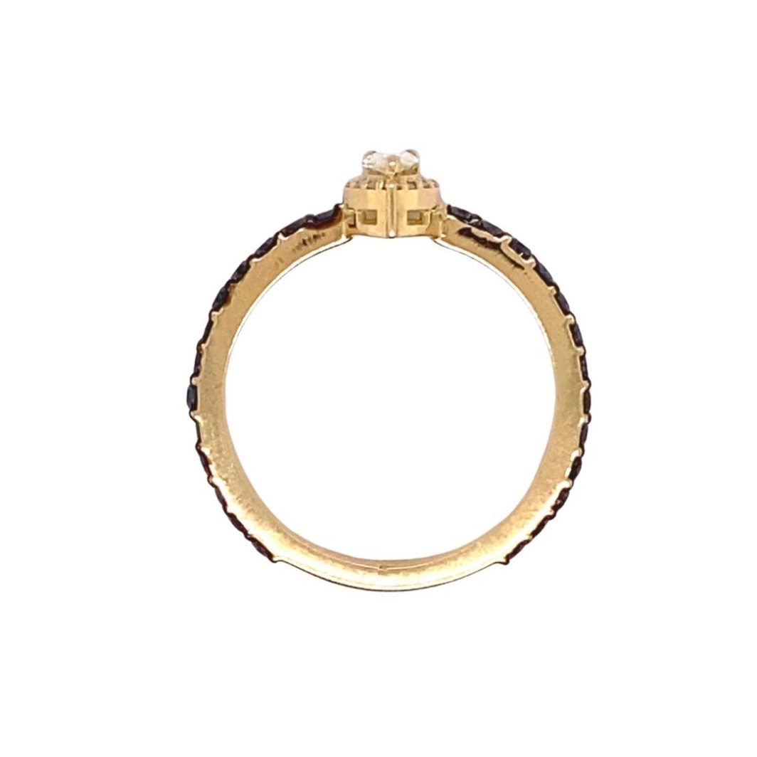 a gold ring with black and white stones