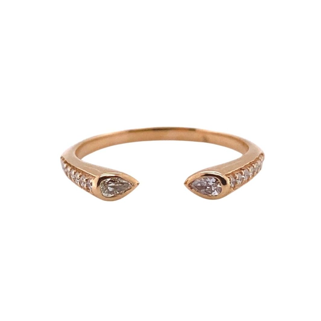 a gold ring with two diamonds on it