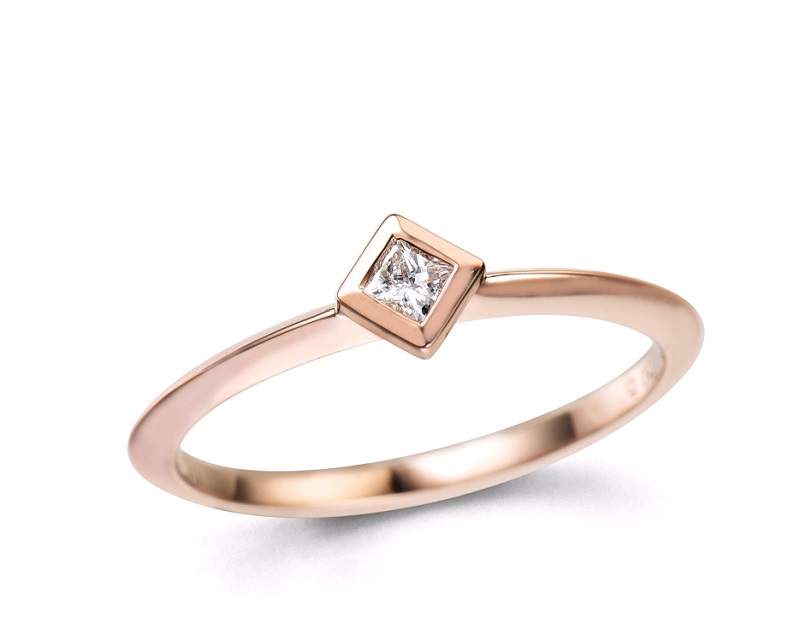 a rose gold ring with a princess cut diamond