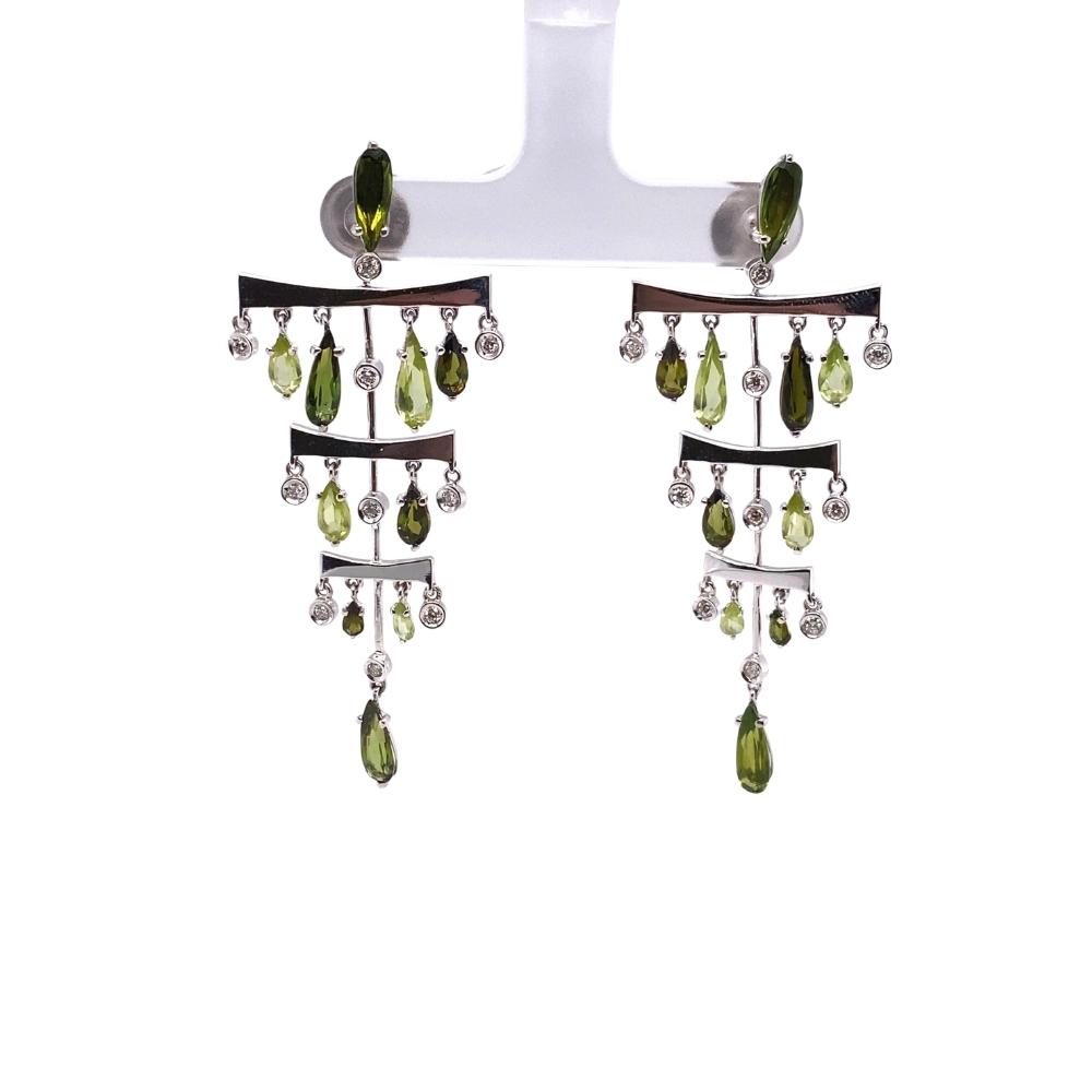 a pair of green and white earrings hanging from a hook