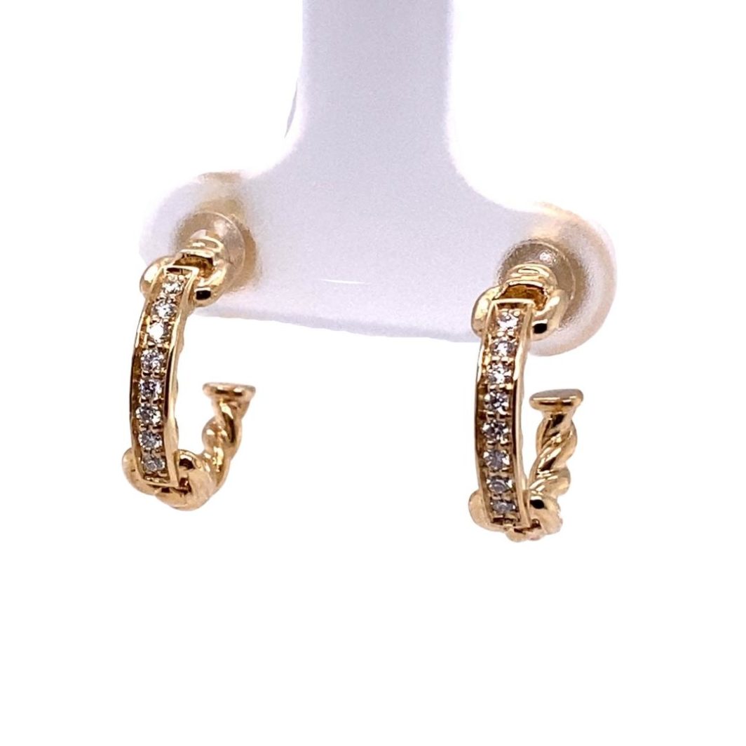 a pair of gold tone hoop earrings with white stones