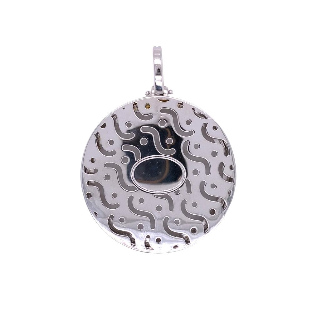 a silver pendant with an abstract design on it