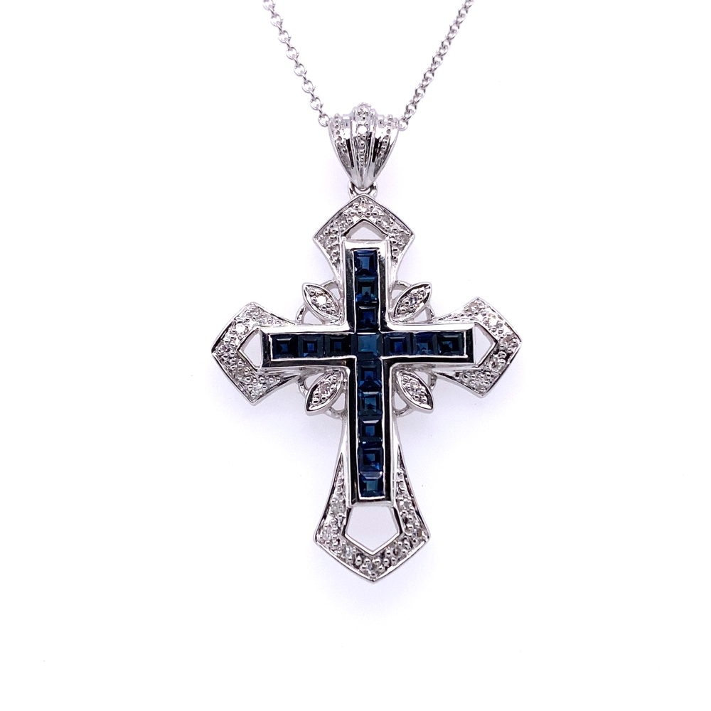 a cross pendant with blue and white stones