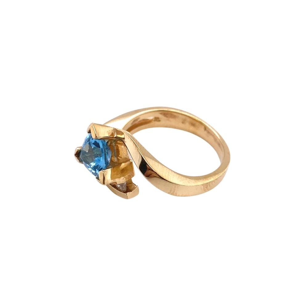 a yellow gold ring with a blue topazte