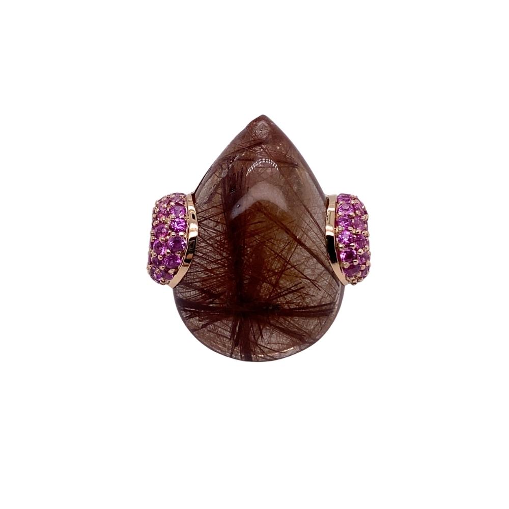 a brown stone ring with pink stones on it