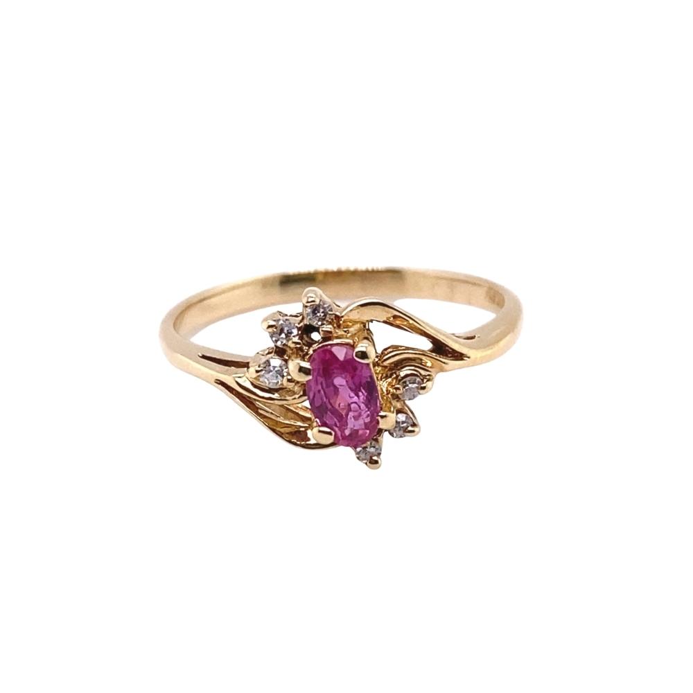 a gold ring with a pink stone and diamonds
