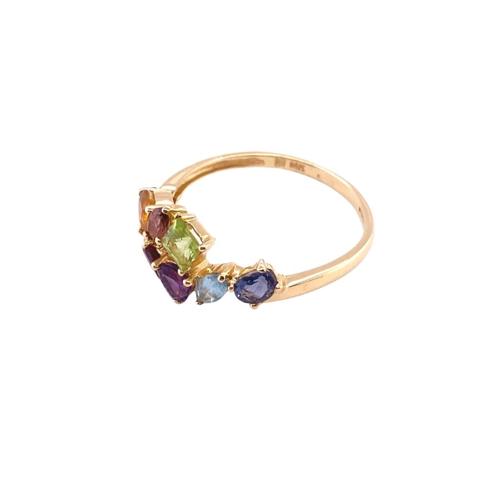 a gold ring with three different colored stones