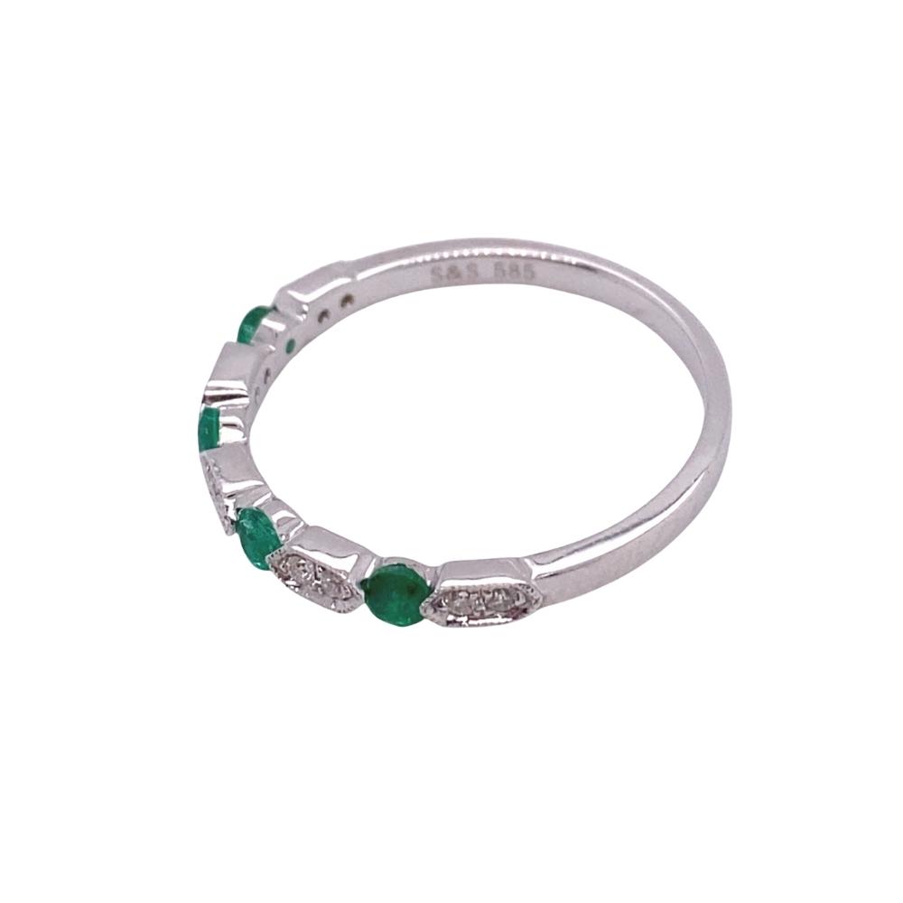 a white gold ring with emerald and diamonds